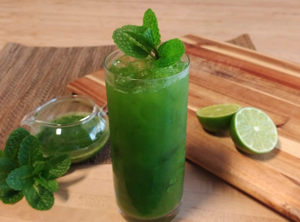 A tall glass of Organic Mint Matcha Faux-jito using the Mighty Leaf recipe for this mocktail spin on a mojito, but adding Organic Mint Matcha to the alcohol-free cocktail